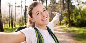 Happy,Woman,,Portrait,And,Trekking,With,Backpack,For,Video,Call,